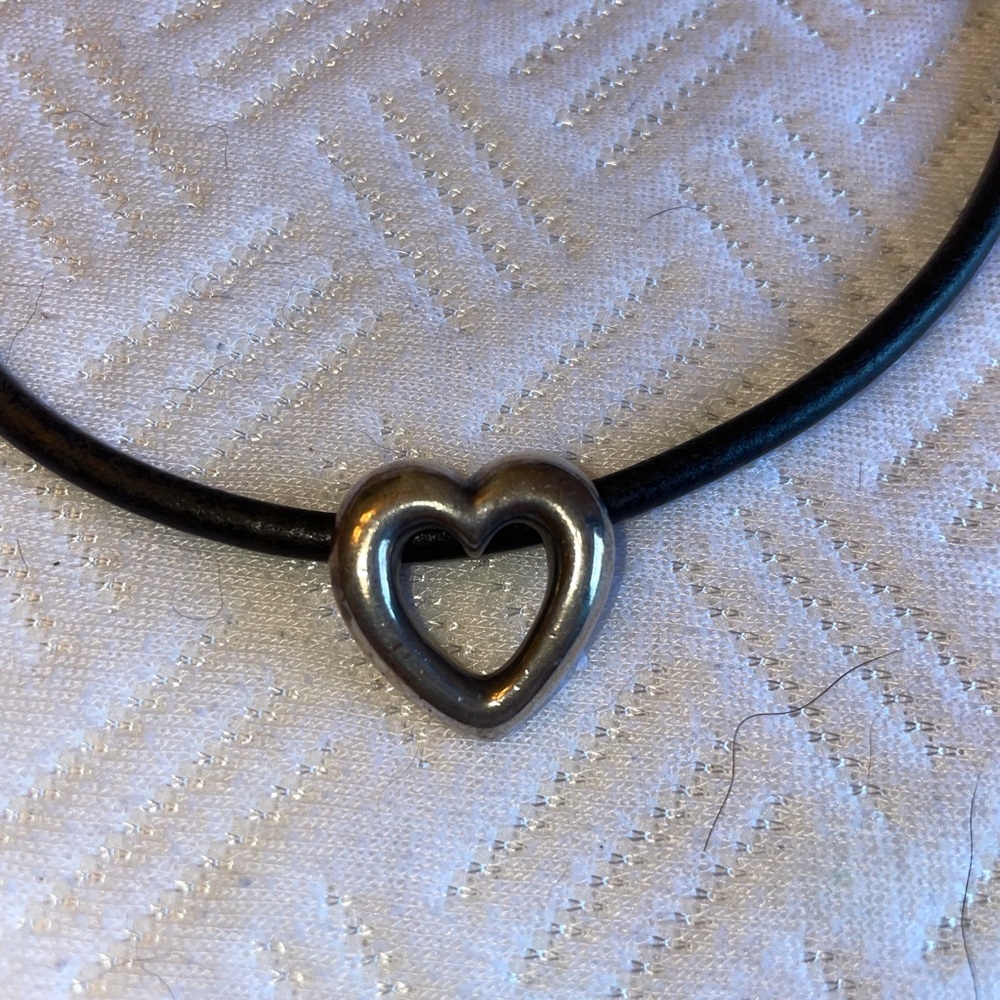 James Avery heart pendant on black leather.